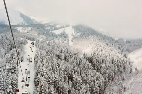 Ski lift above a snow-covered forest near Park City, Utah
